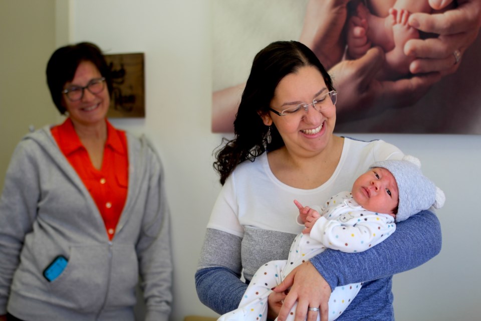 Julie Pohoresky, a registered midwife at the Airdrie Midwives clinic, served during Rachel Copeland's pregnancy (pictured with her new born). 