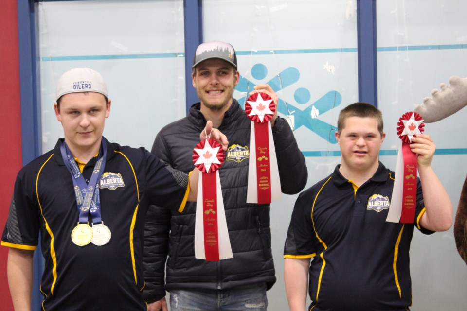 Airdrie Special Olympics athletes (left to right) Brendan, Christian, and Luke hold up their parade marshal ribbons on May 24 at the BGC Youth Centre. The three will take part in the upcoming Airdrie Canada Day Parade on July 1.