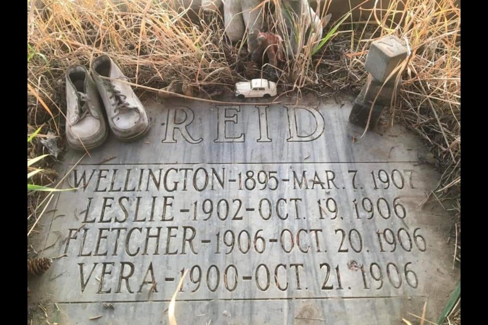 The headstone of four young kids buried north of Crossfield.