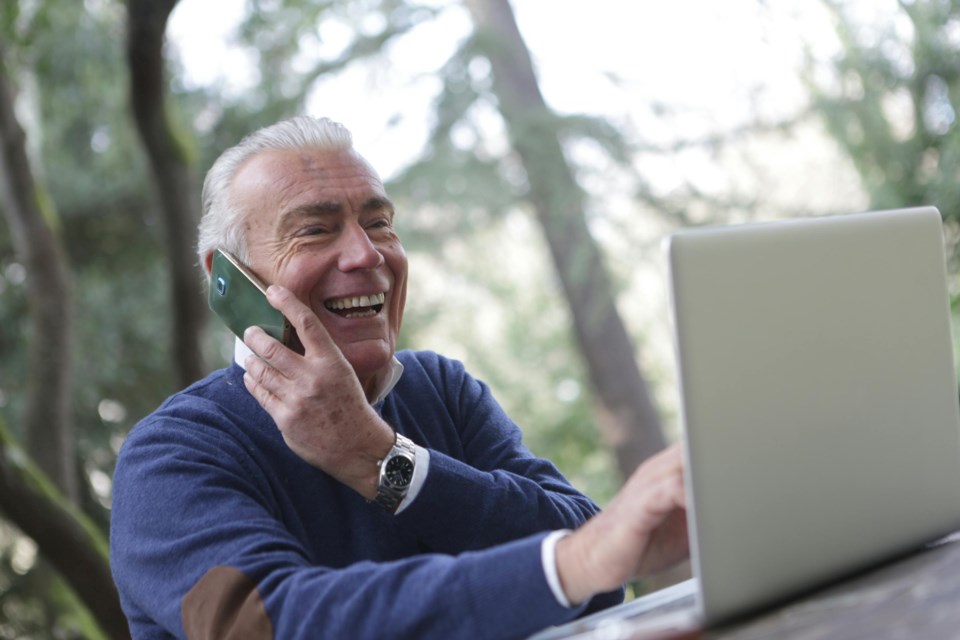 senior-on-computer-and-phone