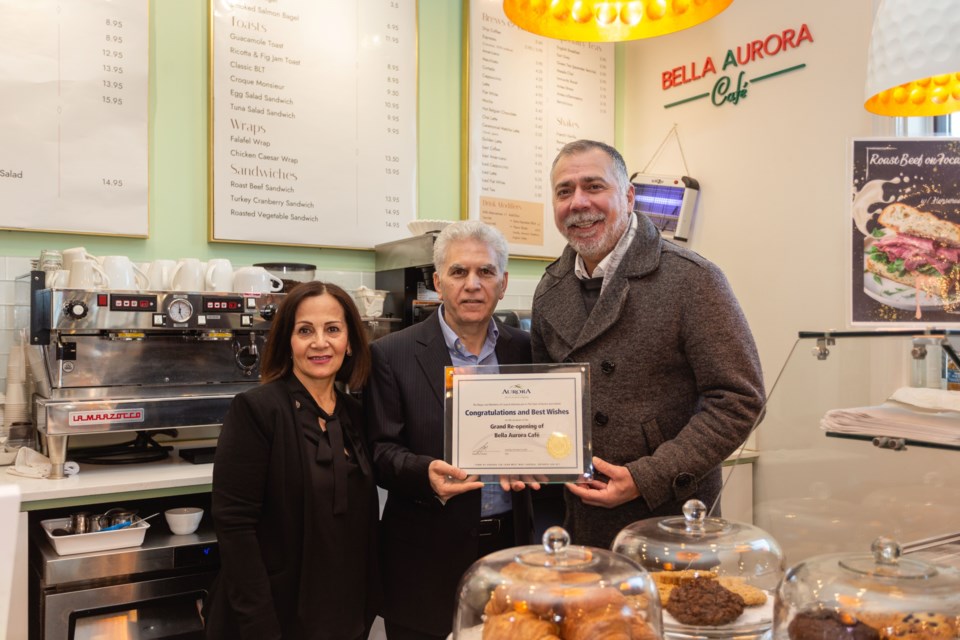 Behnaz and Hossein Nazari and Aurora Mayor Mrakas celebrate the opening of  Bella Aurora Café.