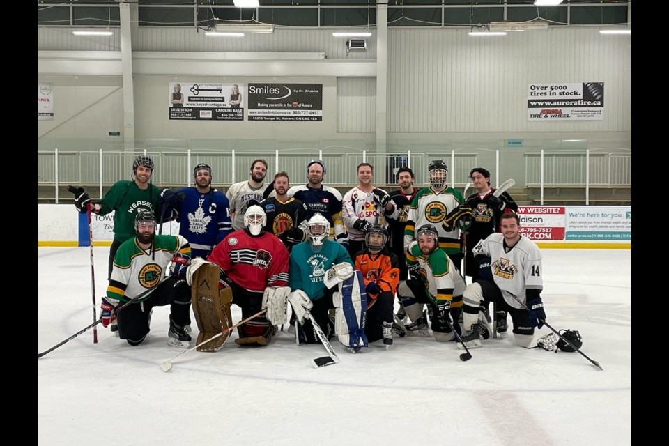 Patrick Servideo (back row, second from left) and Julian Antonini (back row, fourth from left) organized the Hockey Ends Hunger charity game last year, raising more than $1,000 and collecting food donations for the Aurora Food Pantry.