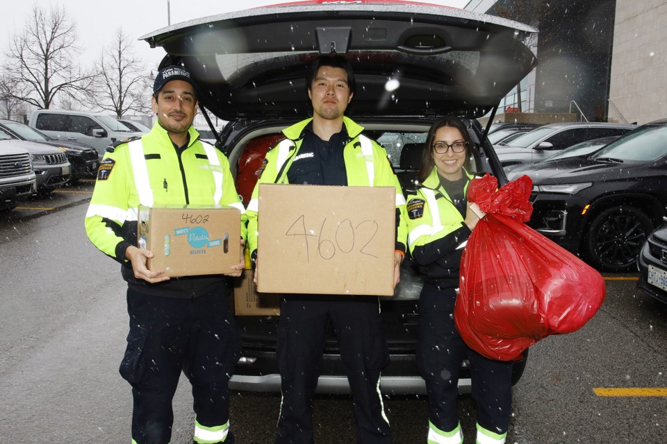 York Regional Police and their partners gathered at its Aurora headquarters Dec. 18 to organize the gifts for families across the region as the Holiday Heroes campaign wraps up. York Region Paramedic Services members  Aman Chhokar, Timothy Ho, and Christina Beishuizen load a vehicle.