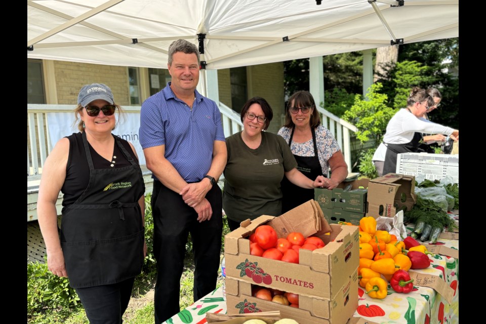 Volunteers Pat Wallace and Doug Steele (from left), market co-ordinator Chantal McCallum and volunteer Marianne Wilcock at the Aurora fresh food market.