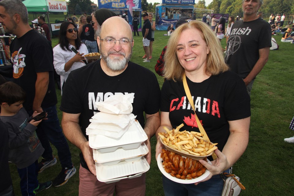 Andrew and Vesta McGeown are loaded down at the first night of the Aurora Ribfest in Machell Park. Check the related articles for the full schedule of food, music and fun that continues to Sunday.