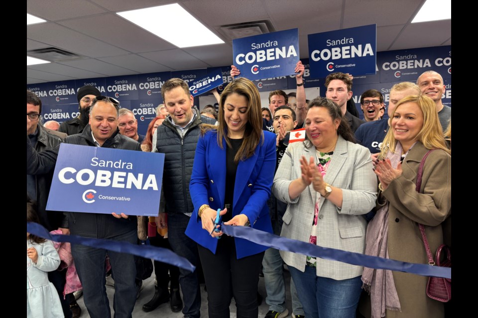 Newmarket-Aurora Conservative candidate Sandra Cobena cuts the ribbon at her campaign office in Newmarket on Saturday, March 22.