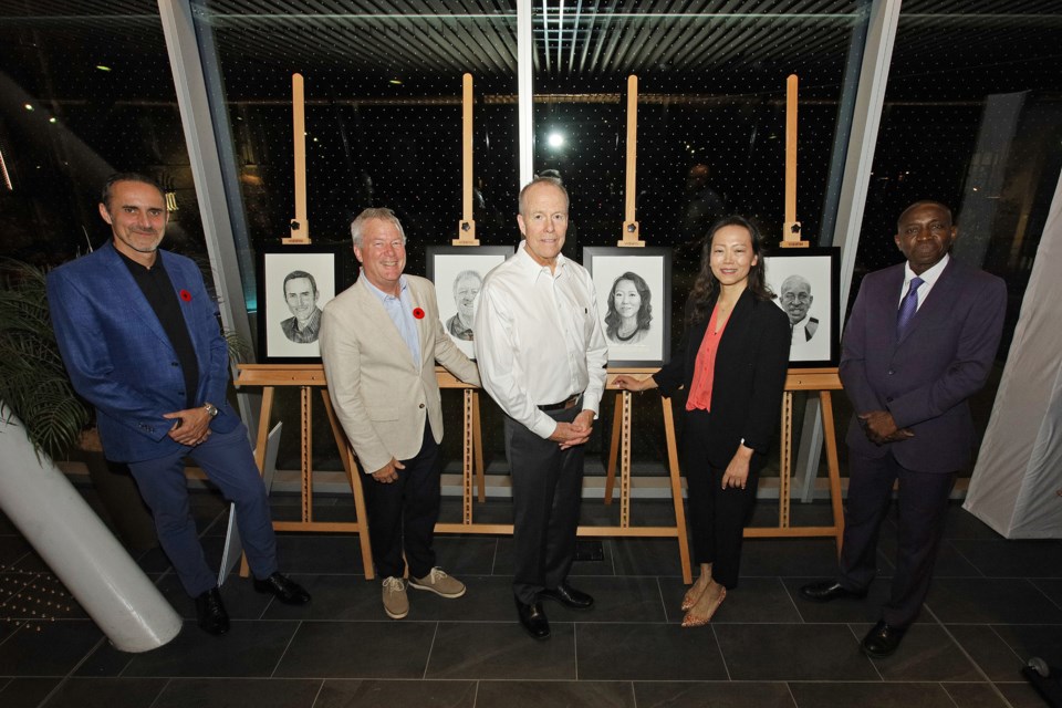 Aurora artist Paul Riley (centre) unveiled the portraits of 2024 inductees Marcel Gery, Sandy Townsend, Grace Wong,  and Milton Hart at an Aurora Sports Hall of Fame VIP reception at Aurora Town Square Nov. 6. The event honoured inductees, sponsors, supporters as a prelude to the induction ceremony tonight.