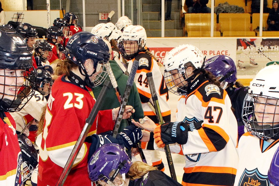 Hosting Central York Girls Hockey Association Panthers and Farmington Hill Little Caesars exchange pins during the International Silver Stick finals for U9, 11 and 15 girls taking place in Aurora and Newmarket Feb. 7 to 9.