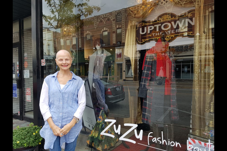 Tracey Baker stands outside her ZuZu Fashion Boutique window that is decorated for the 21st annual Barrie Film Festival. Shawn Gibson for BarrieToday