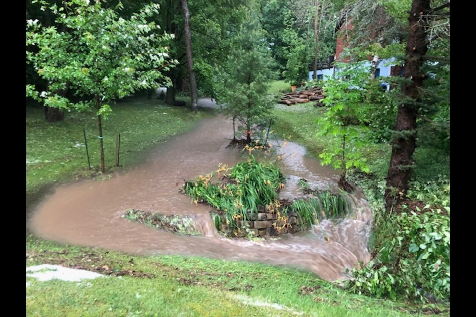 A sudden deluge of rain created this sweeping river next to the Barnum property in Midhurst.