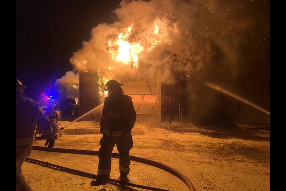 Oro-Medonte fire crews work to extinguish an early morning blaze at an automotive business on Line 12 in the township.