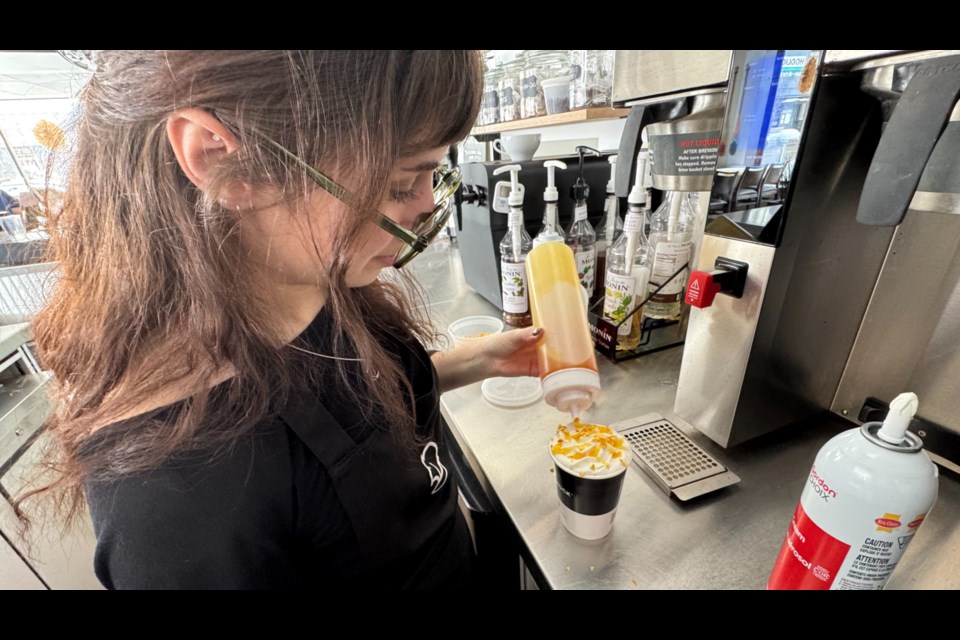 Parker Sandiford makes an orange creamsicle hot chocolate, the signature drink at Beaver Rock Cafe during this year's Hot Cocoa Trail in downtown Barrie.