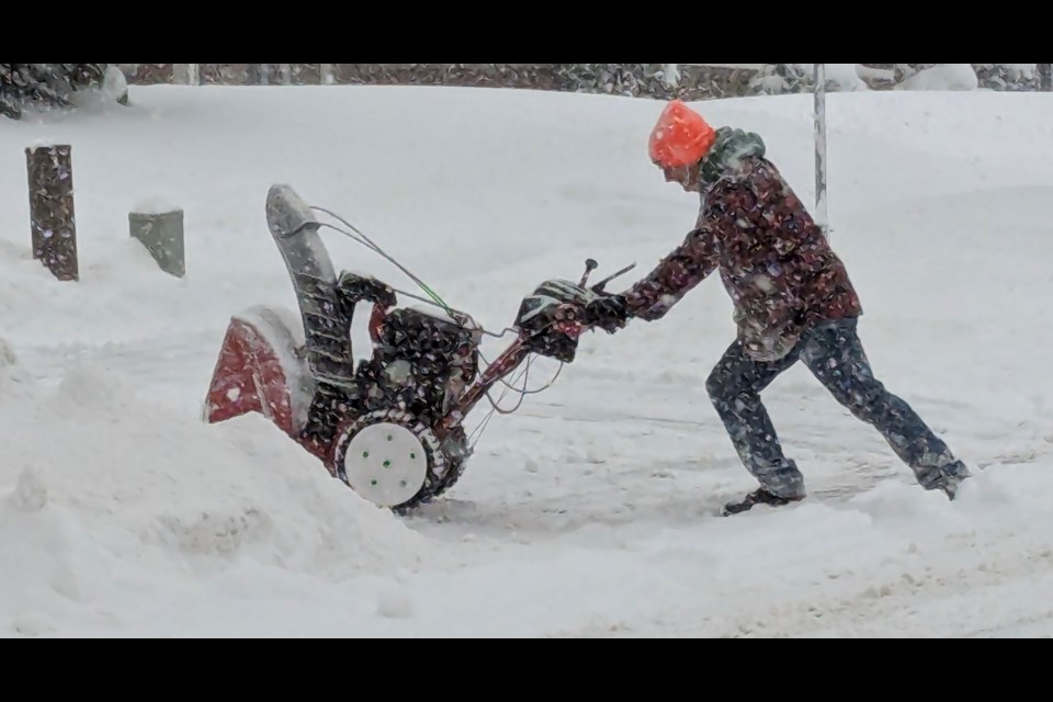 Kevin Shuttleworth clears his driveway in Barrie on Saturday morning.