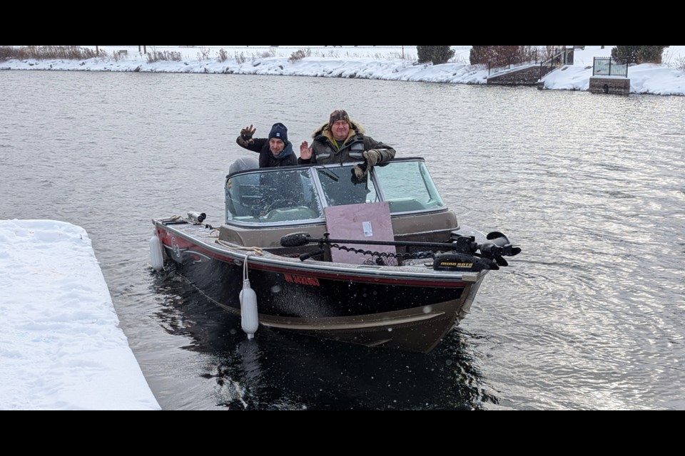 Oleg Zhechuk, of Mississauga, left, and Eduard Prysyazhnyuk of Barrie, head into Kempenfelt Bay for some fishing Sunday morning