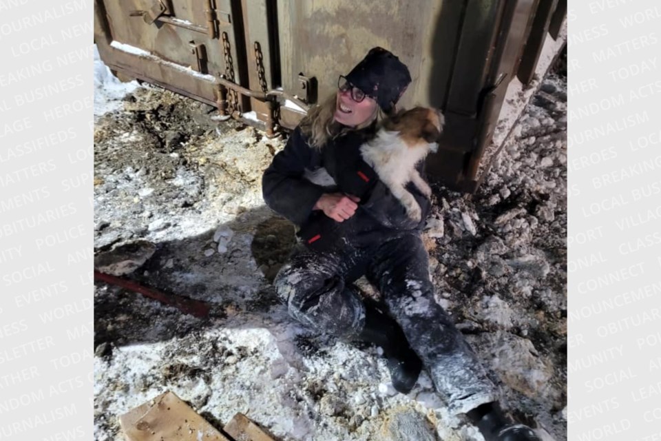 Martha Mesley hugs her pup Linus tight after he spent several freezing cold hours trapped under a container on the family's Minesing farm.