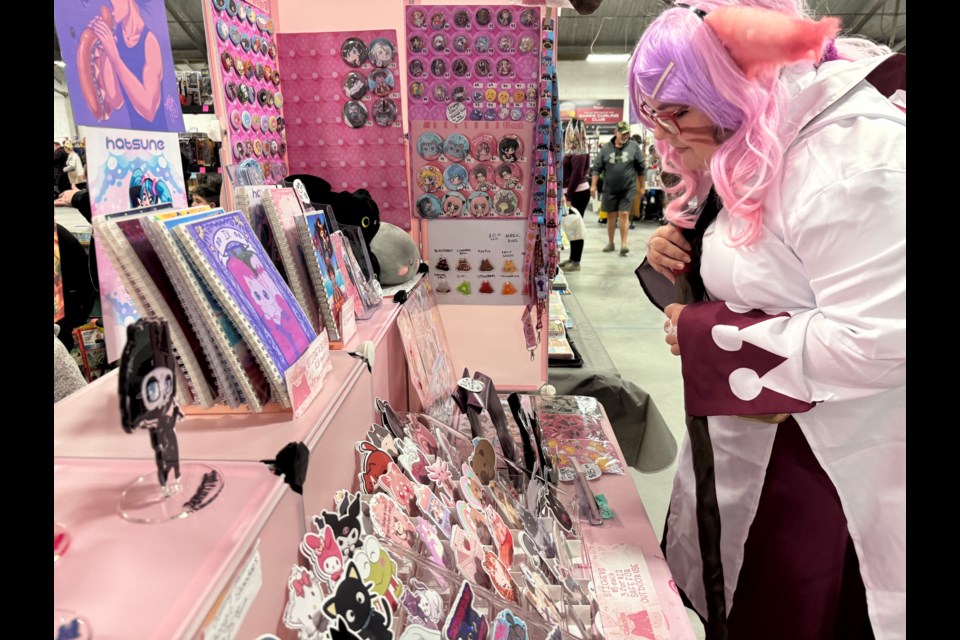 Huntsville resident Kayla Beach, dressed as a White Mage from Final Fantasy, checks out a display at Barrie ComiCon on Saturday.