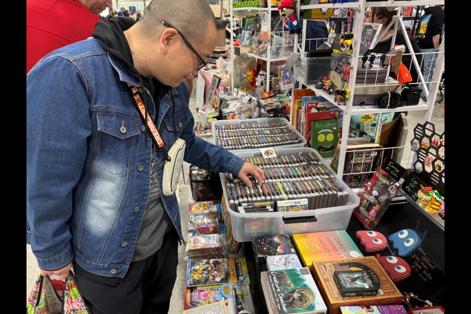 Kevin Chau scopes out a table looking for unique finds at the Barrie Game Exchange on Sept. 8 at Eastview Arena.