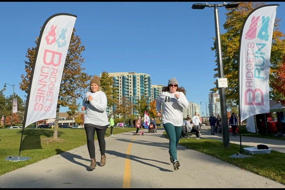 Marnie Lightfoot, regional director of the Women and Children’s Health Network and board member of Bridget’s Bunnies and co-founder Theresa Morrison warm up before the annual Bridget's Run in Barrie. 
