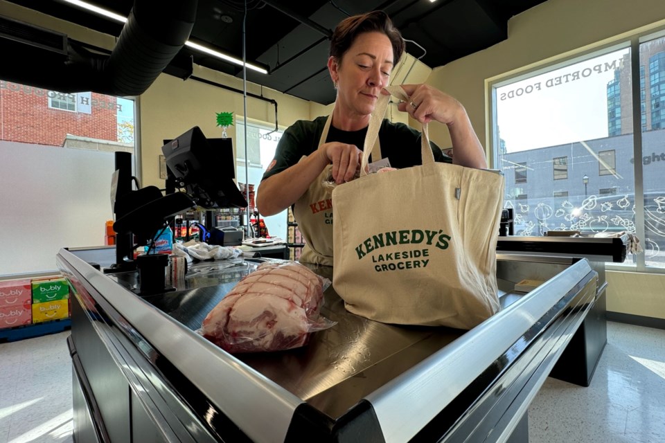 Meaghan Oldershaw bags groceries at Kennedy's Lakeside Grocery in downtown Barrie.