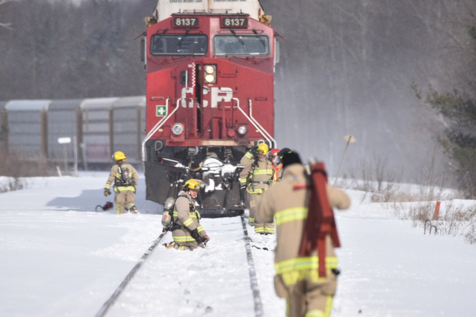 Springwater Township firefighters get to work after a CP train problem Monday morning.