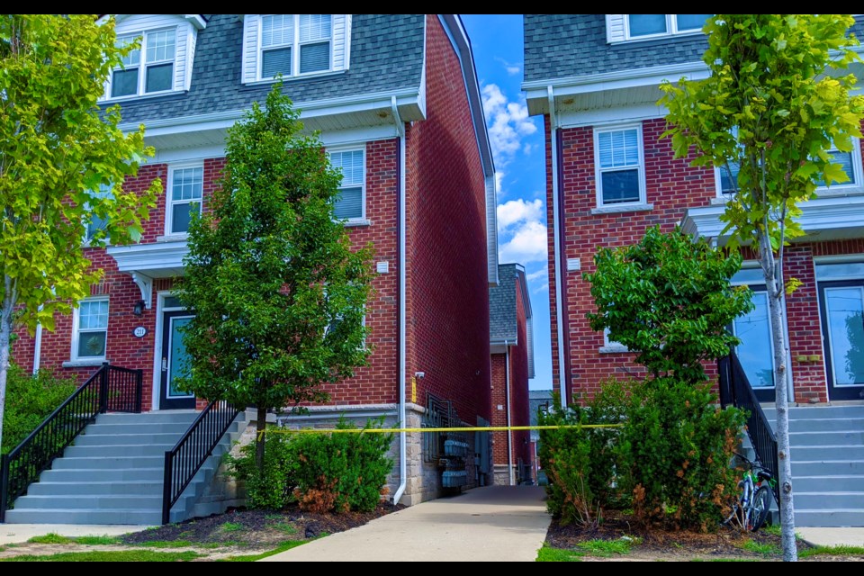 Police tape was up between units 201 and 212 at Foundry Georgian in Barrie on Saturday following a shooting.