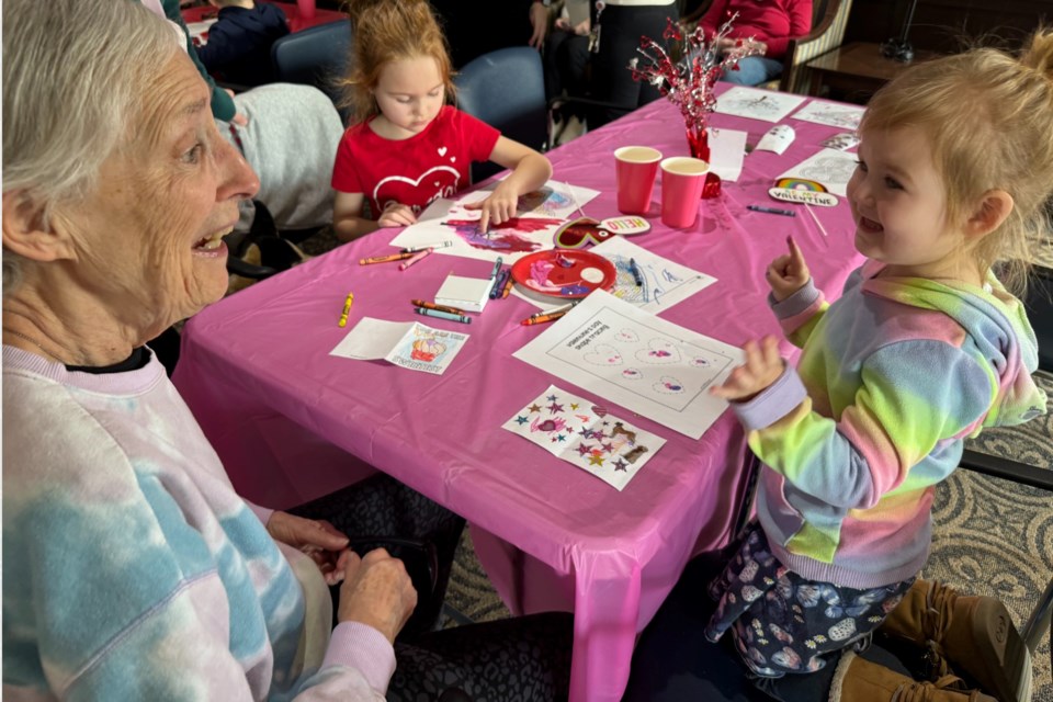 Adele Kostiak gets messy with Emily and Macy Blair during a intergenerational bonding event held Feb. 23, 2024 at The Barrieview retirement facility. 