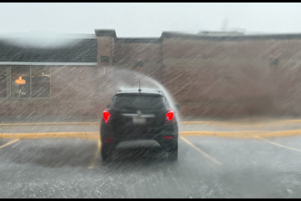 High winds can be seen blowing the rain over this vehicle in Barrie during Wednesday's storm. Kevin Lamb/BarrieToday