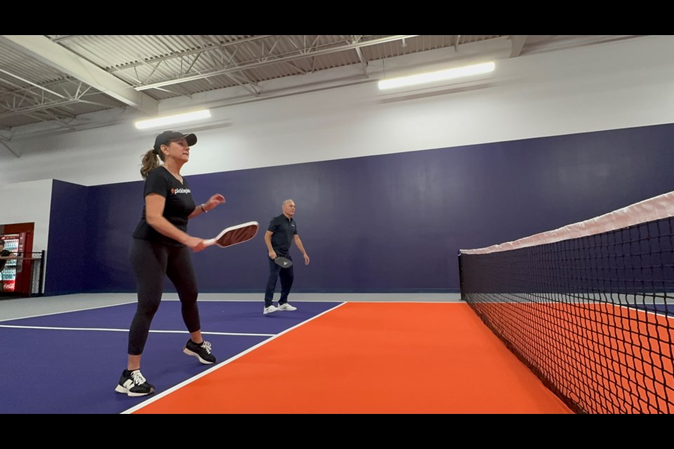 Players compete in a game of pickleball at Pickleplex Social Club in Barrie.