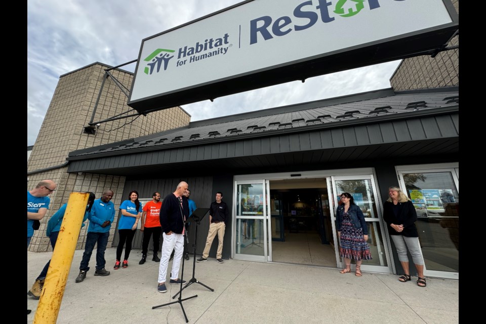 Habitat for Humanity Huronia chief executive officer Robert Cikoja and ReStore volunteers celebrate the Barrie store's anniversary on Saturday.