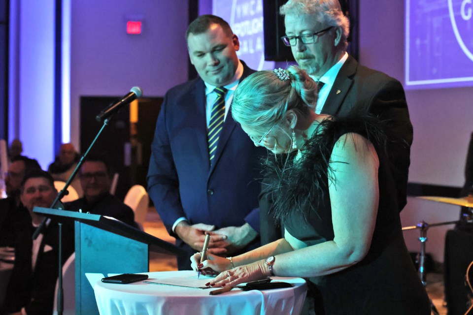 YMCA Simcoe/Muskoka chief executive officer Jill Tettmann signs a lease agreement for their new facility on Bayview Drive with Barrie Mayor Alex Nuttall on Friday night during their Spotlight Gala at Liberty North.