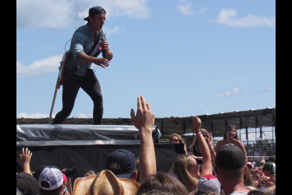 Eric Ethridge interacts with the crowd that responded with cheers Saturday at the Boots and Hearts Festival at Burl's Creek. Shawn Gibson/BarrieToday                               