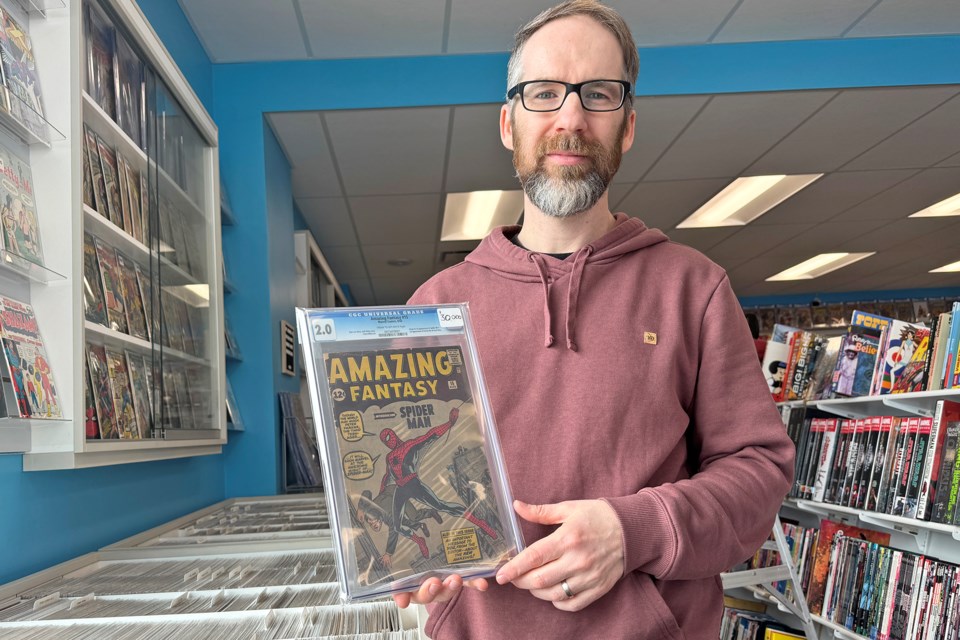 Marc Sims, owner of Big B Comics on Essa Road in Barrie, shows off an Amazing Fantasy comic book from 1962, valued at $30,000, in which Spider-Man makes his first appearance.