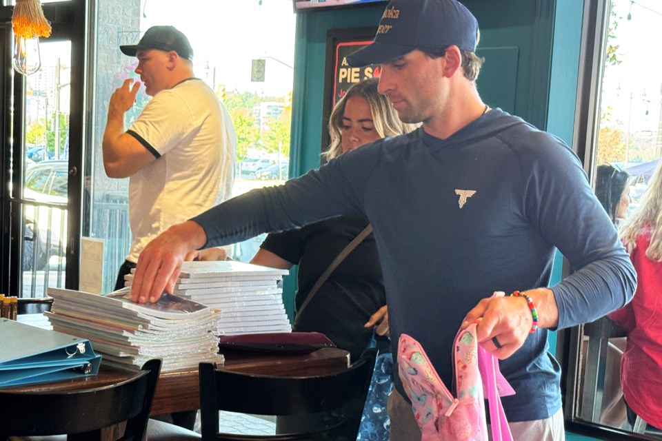 Toronto Maple Leafs captain John Tavares and his wife, Aryne Fuller, fill backpacks with school supplies for the PIE Education Backpack Campaign, which kicked off at PIE Wood Fired Pizza on Victoria Street in Barrie on Wednesday afternoon.