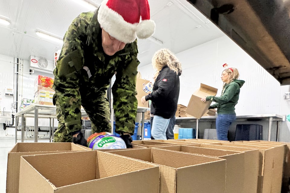 The 5th annual turkey dinner event in support of the Angus Food Bank got underway Friday morning with some packing and delivery help from volunteers and a few members of Canadian Armed Forces Base Borden at Bokkie’s Biltong, a South African butcher shop on Saunders Road in Barrie.