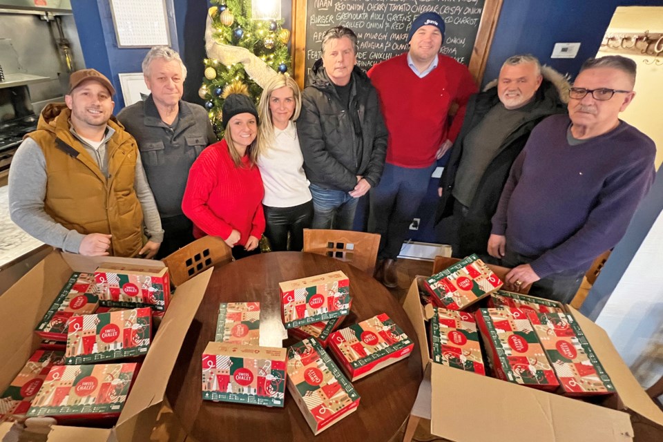 Cody Clark and Melanie Barrett, owners of Groovy Tuesday's Bistro, host a walk-in meal pickup event for the needy on Christmas Eve. Helping them were friends, along with organizer Bruce Stewart, and Barrie Mayor Alex Nuttall along with Deputy Mayor Robert Thomson.