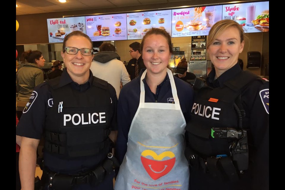 Barrie Police officers Shannon Green, left, Lori McIlravey, right and co-op student Kylie Marshall on greeting duties at the Dunlop Street McDonald's for McHappy Day.
Sue Sgambati/BarrieToday
