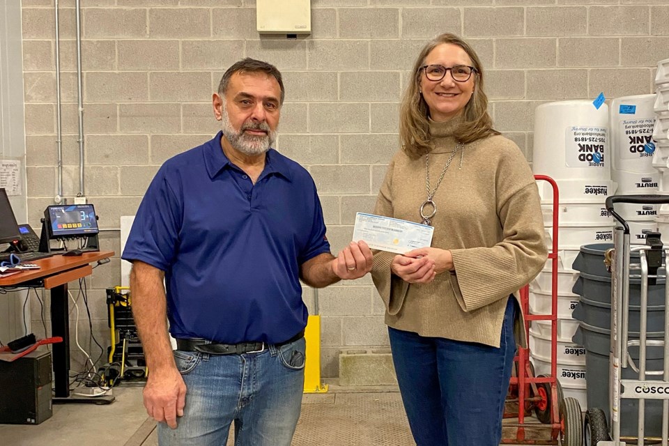 Tony Morello, UFCW Local 175 executive board vice-president and union steward at Metro Collingwood (left) presents a cheque to the Barrie Food Bank, which is accepted by Sharon Palmer, executive director.
