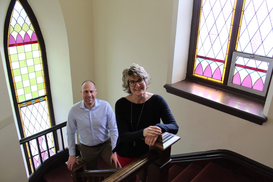 Rev. Will Haughton and longtime church member Laurie Crosson are shown in the front stairwell of Collier Street United Church in downtown Barrie. Raymond Bowe/BarrieToday
