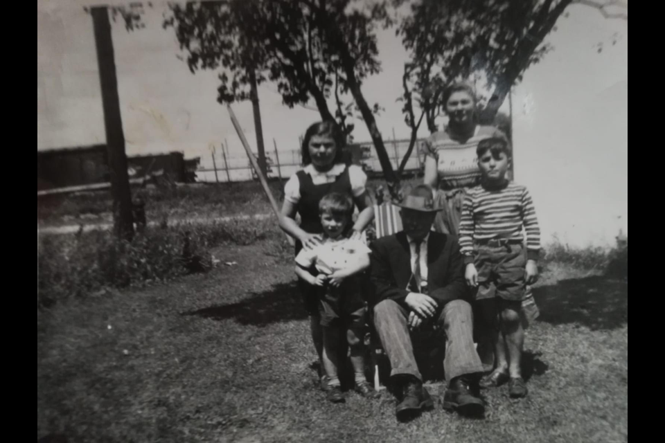 Antonio 'Mr. Tony' Curcio is surrounded by four of his grandchildren, Guido, Angela Maria, Wanda and Francesco Antonio De Simone. The photo was taken on the lawn of 89 Gowan St. with the railway lands and lake behind them. Photo courtesy of the Barrie Historical Archive