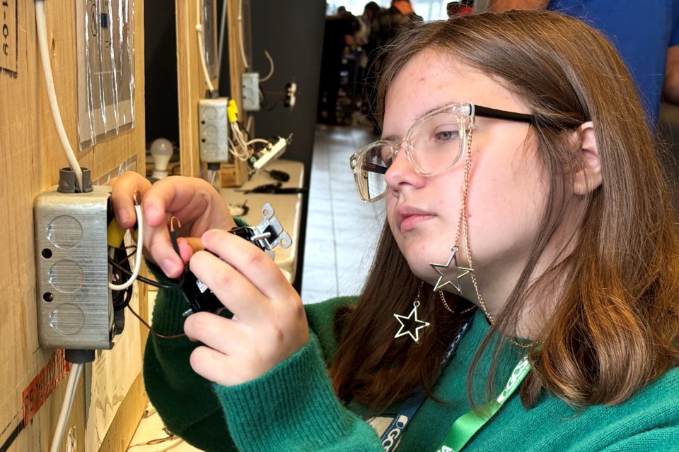 Danica Hanson, 13, gets a hands-on lesson about electrical work, as girls in grades 7 to 9 learned about the possibilities of finding a career in skilled trades, at a Georgian College event in Barrie on Saturday.