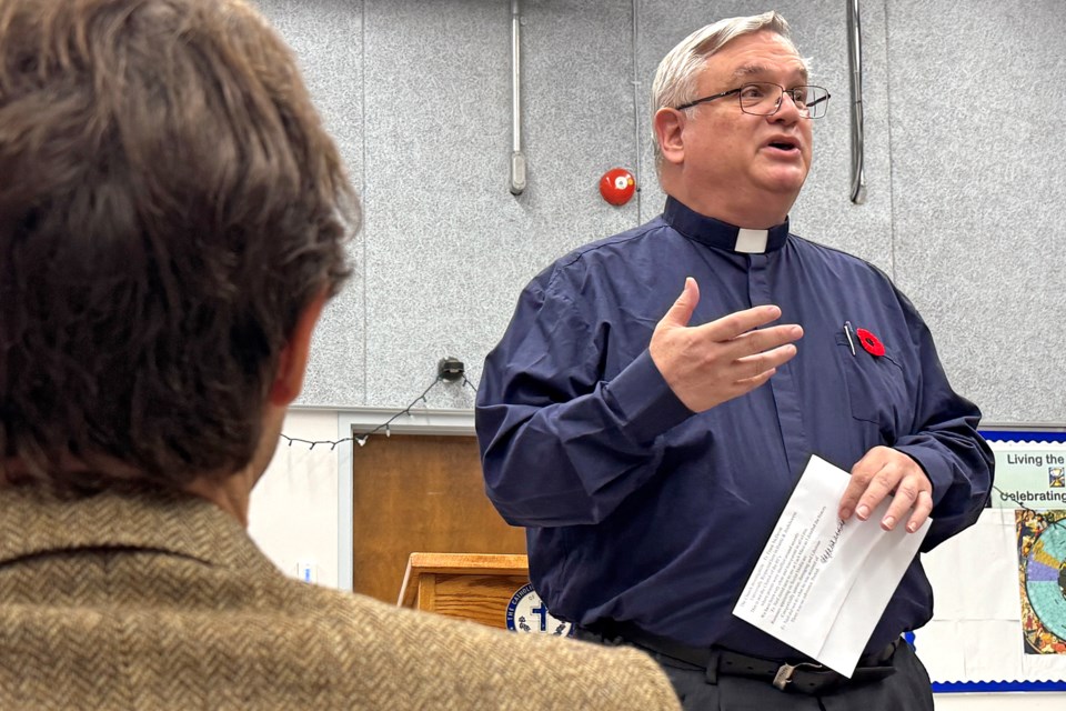 Father Larry Leger addresses the audience gathered at St. Mary's Catholic Church in Barrie on Tuesday night. The tense discussion with parents dealt with the decision to reinstate Father Neil Pereira after charges of sex assault with a minor in 2023 were withdrawn.