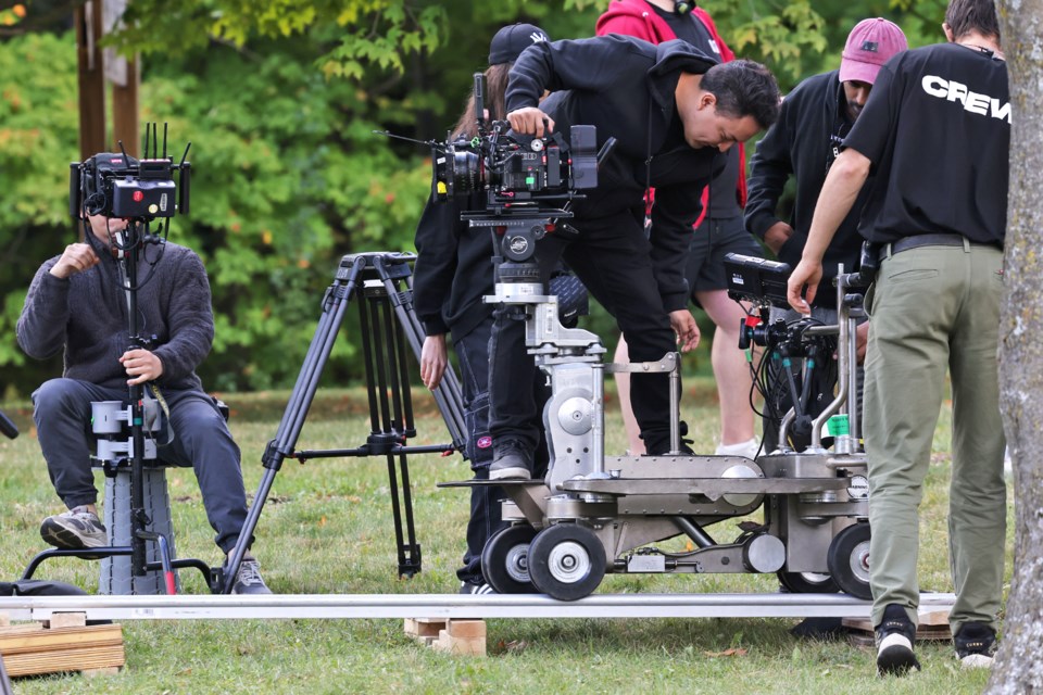 Crew members construct a rail camera on a film set in Sunnidale Park in Barrie on Wednesday.