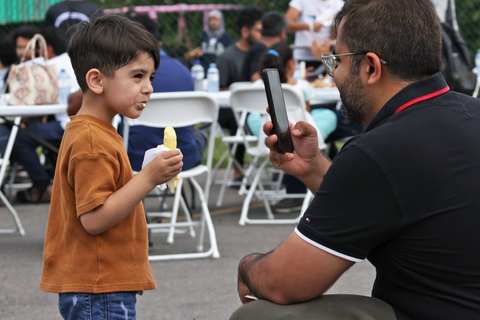 Visitors capture a moment at the annual community barbecue party held at the Barrie Mosque on Ferris Lane in Barrie on Saturday, Aug. 23.