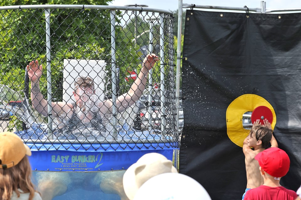 Jeff Gartner falls victim to a dunk tank cheater at the Ardagh Bluffs Community Super Soaker Block Party event on Saturday at Summerset Park in Barrie.