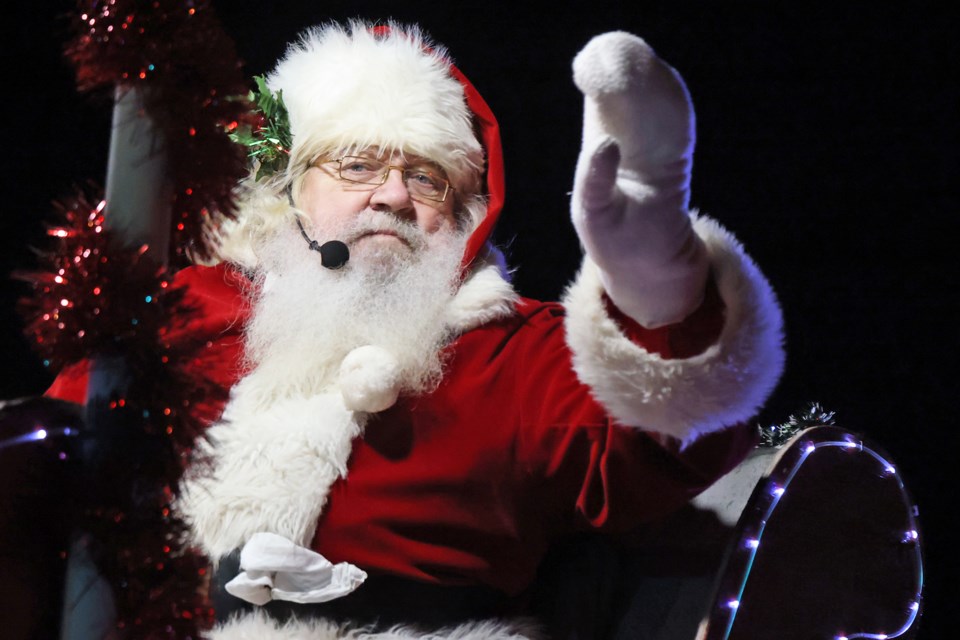 Santa waves to the kids from atop his float during Barrie's Santa Claus parade on Saturday along Lakeshore Drive.