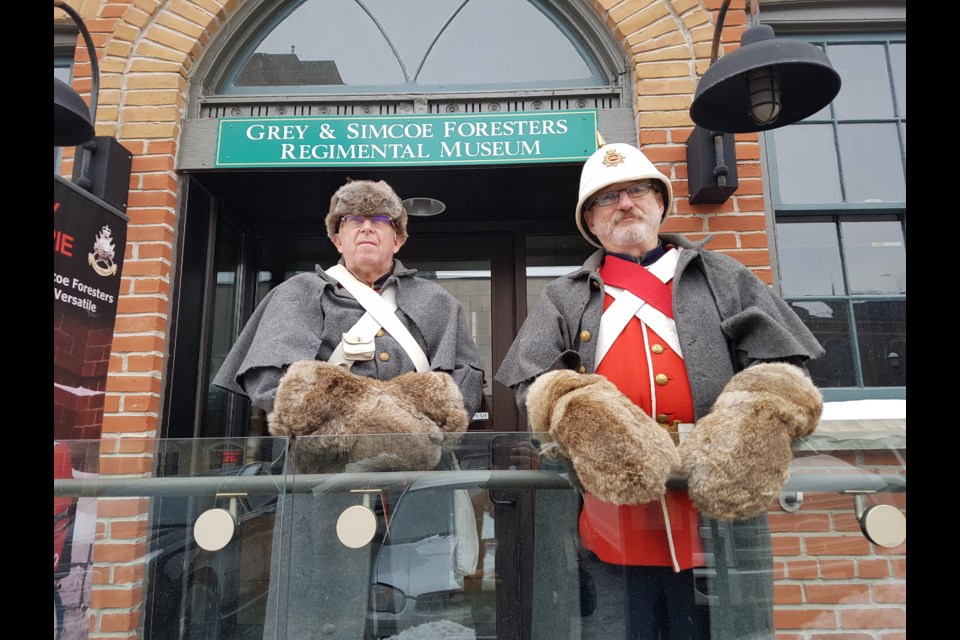 Roger Holliday, left, and Darcy Murray welcome visitors to the Grey and Simcoe Foresters museum during Winterfest weekend. Shawn Gibson/BarrieToday