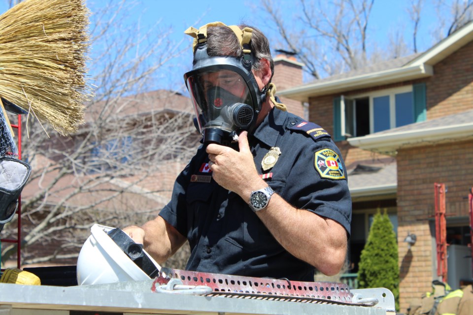 Barrie fire prevention officer Jeff Holmyard, a certified fire and explosion investigator, gears up prior to entering a home at 98 Chieftain Cres., in the city's south end, following a mid-morning blaze. What caused the blaze remains under investigation. Raymond Bowe/BarrieToday