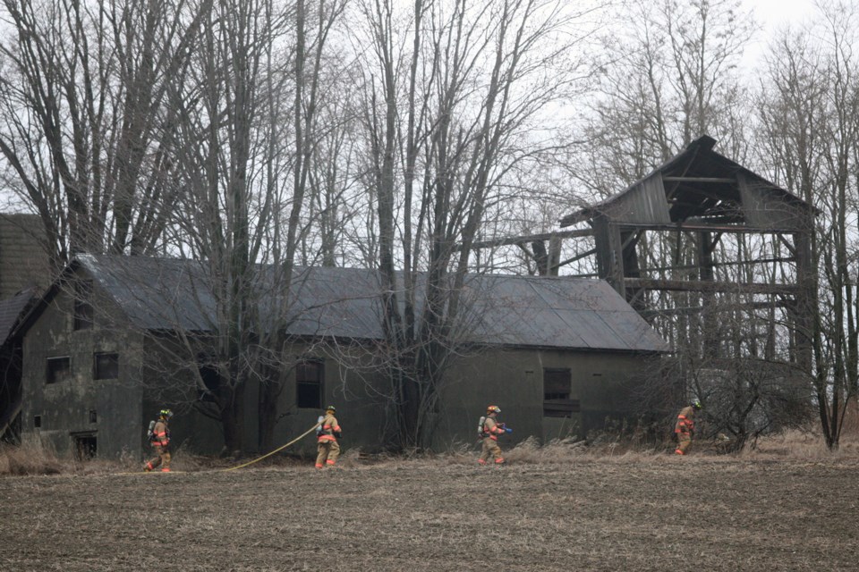 Firefighters with Bradford West Gwilimbury Fire and Emergency Services seen during the aftermath of a barn fire on Yonge Street at Line 12 west of Bradford this evening. Kenneth Armstrong/BarrieToday