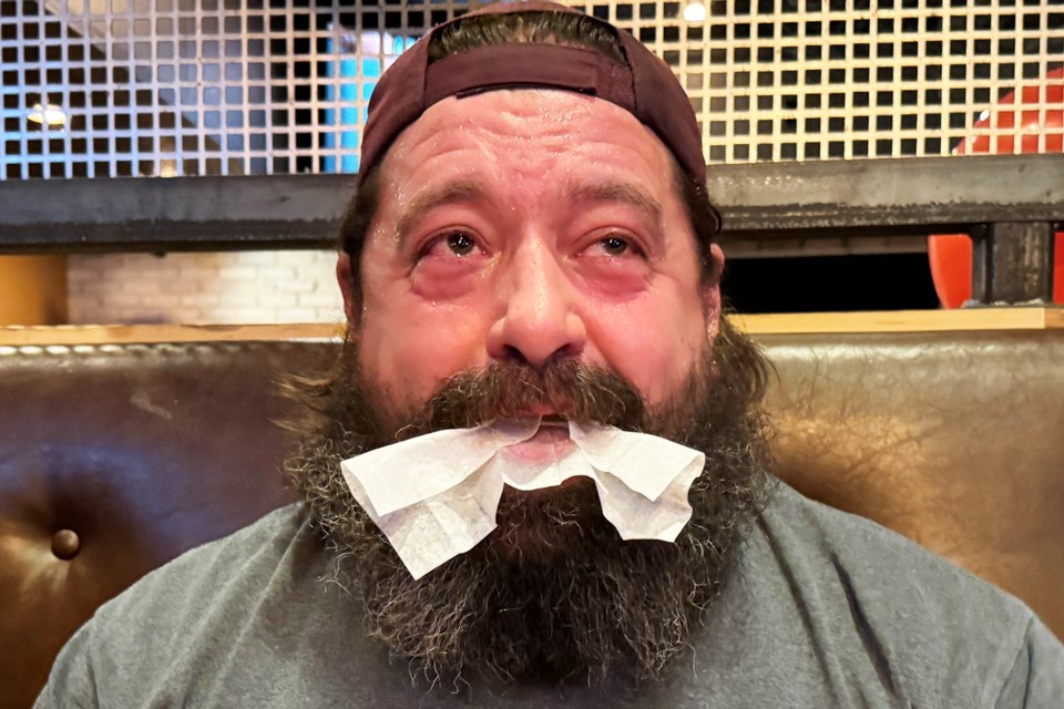 Sweat and tears after the thrird round of the hot wings eating contest at Kelseys Original Roadhouse on Bayfield Street in Barrie on Wednesday, Jan 10, 2024. The winner received free wings for a year.