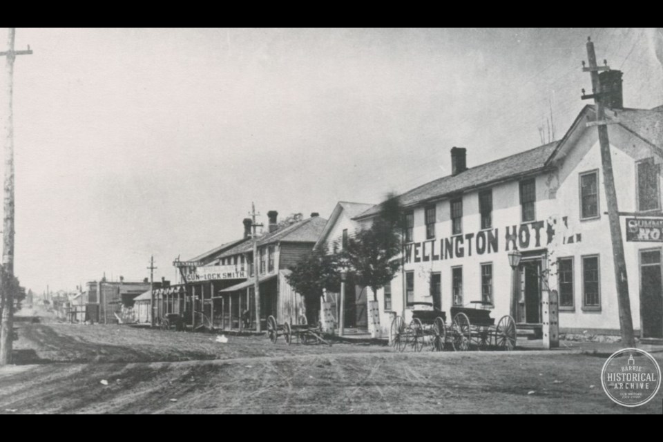 Looking at the north side of Dunlop Street West from Five Points in 1860. The Hurst carpentry shop was located half way down this block.